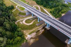 aerial view on huge bridge with a wide multi-lane road across a wide river photo