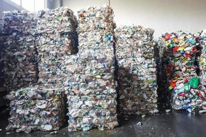 Plastic bales at the waste processing plant. Separate garbage collection. Recycling and storage of waste for further disposal. Business for sorting and processing of waste. photo