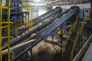 moving conveyor transporter on Modern waste recycling processing plant. Separate and sorting garbage collection. Recycling and storage of waste for further disposal. photo