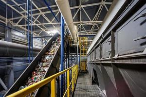 moving conveyor transporter on Modern waste recycling processing plant. Separate and sorting garbage collection. Recycling and storage of waste for further disposal. photo