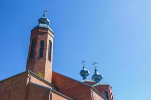 Dome of Orthodox Christian Church of red brick in summer sunny day photo