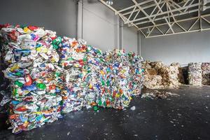 balas de plástico de basura en la planta de tratamiento de residuos. reciclaje separado y almacenamiento de basura para su posterior eliminación, clasificación de basura. negocio de clasificación y tratamiento de residuos. foto