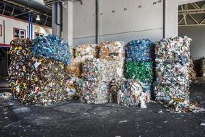 Plastic bales of rubbish at the waste treatment processing plant. Recycling separatee and storage of garbage for further disposal, trash sorting. Business for sorting and processing of waste. photo