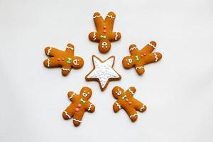 Handmade festive gingerbread cookies in the form of five people around a star photo