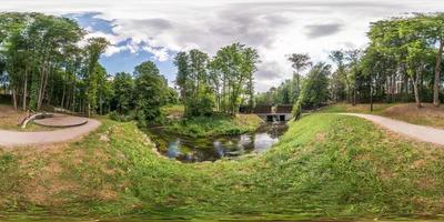 full seamless spherical panorama 360 by 180 angle view on the shore of small river in sunny summer day in equirectangular projection, skybox VR virtual reality content photo