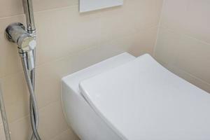 bidet in modern toilet with  wall mount shower attachment photo