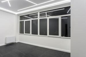 windows in empty unfurnished loft room interior white style color photo