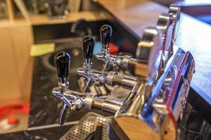 row of cranes for bottled craft beer and drinks in elite bar photo