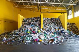 Plastic bales at the waste processing plant. Separate garbage collection. Recycling and storage of waste for further disposal. Business for sorting and processing of waste. photo