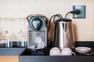 Espresso coffee capsules maker and cup on table photo