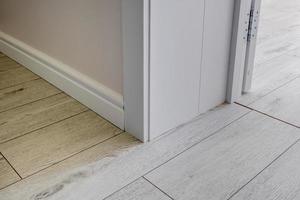 Detail of corner flooring with intricate crown molding and plinth. photo