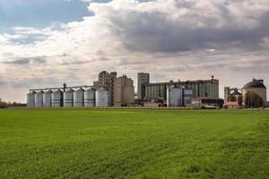 agro silos granary elevator on agro-processing manufacturing plant for processing drying cleaning and storage of agricultural products, flour, cereals and grain. photo