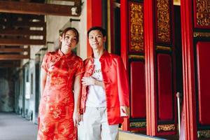 Happy young Asian couple in Chinese traditional dresses photo