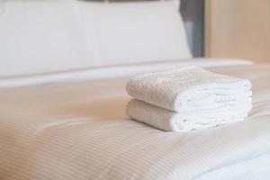 white shower towel on bed photo