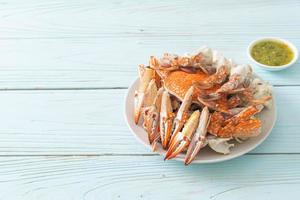 Steamed blue crab with spicy seafood sauce photo