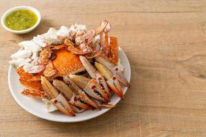 Steamed blue crab with spicy seafood sauce photo