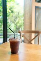 iced black coffee takeaway glass on table in coffee shop cafe restaurant photo