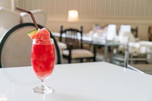 fresh watermelon smoothie glass  on table photo