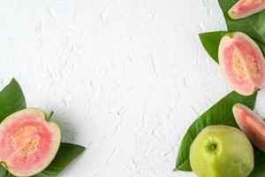 Top view of beautiful red guava with fresh green leaves. photo