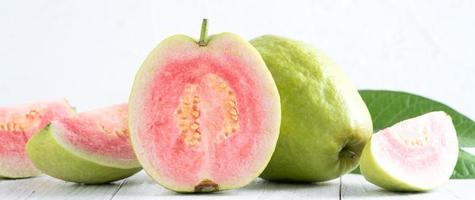 Close up of beautiful red guava with fresh green leaves. photo