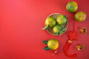 Top view of fresh tangerine mandarin orange on red background for Chinese lunar new year. photo