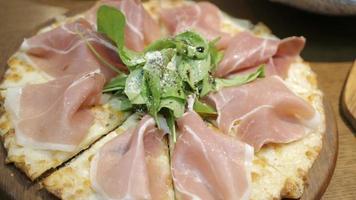 view of a tray of pizza with full of parma ham video