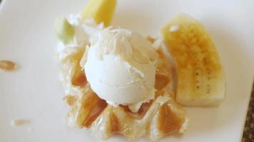 croffle waffles on plate with ice-cream and caramel banana. dessert plate video