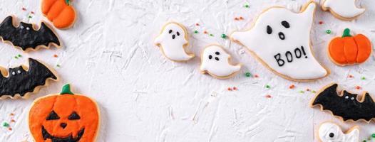 Top view of Halloween festive decorated icing sugar cookies on white background. photo