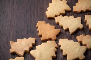 Top view of decorated Christmas tree cookie on wooden table background with copy space. photo