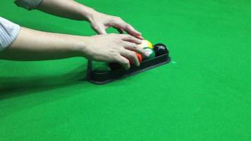 Man setting up the pool ball for begin the game - people in pool snooker indoor sport concept video