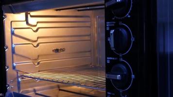 Lady putting homemade bakery cake into oven video