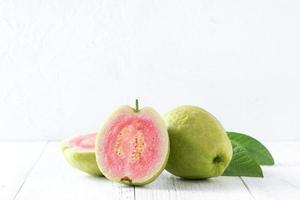 Close up of beautiful red guava with fresh green leaves. photo