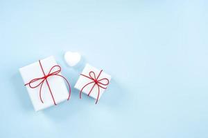 Valentine's Day greeting design concept - Top view of gift box on bright blue background. photo