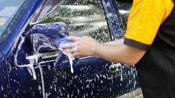 Man wash car using shampoo - every day life car care concept video