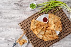 Taiwanese delicious scallion pancake over wooden table background photo