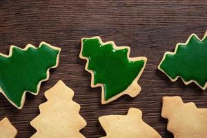 Top view of decorated Christmas tree cookie on wooden table background with copy space. photo