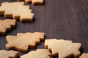 Top view of decorated Christmas tree cookie on wooden table background with copy space. photo