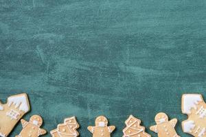 Top view of Christmas tree and snowflake cooikes with gingerbread man wearing mask. photo