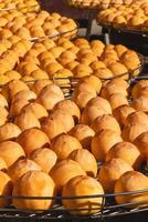Making process of sun exposuring dried persimmon in a sieve in autumn. photo