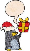 cartoon penguin and christmas present and speech bubble in retro texture style vector