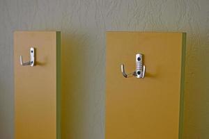 Yellow hanger indoors at home with silver handles photo