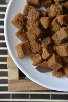 Spicy and spiced breadcrumbs on a white plate close-up. photo