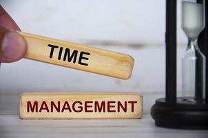 Hand holding wooden blocks with text - Time management. Time concept photo