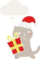 cute cartoon cat carrying christmas present and thought bubble in retro style vector