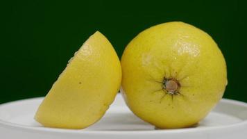 Delicious lemon moving on turntable isolate on the black background. video