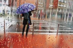 Bilbao, Vizcaya, Spain, 2022 - people with an umbrella on the street in rainy days, autumn season photo