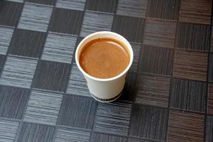 Hot and strong coffee is poured into a cup. photo