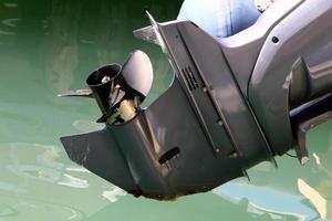 Motor and propeller of a motorboat. photo