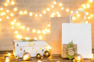 Gift Package for Christmas and new year in eco-friendly materials kraft paper, live fir branches, cones, twine. Tags with mock up, natural decor, hand made, DIY. Copy space. Flatly, background photo