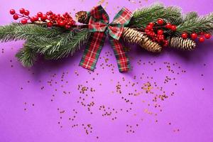 Christmas decor with sparkles of stars on a purple background. New year, holiday mood. copyspace, flat lay photo